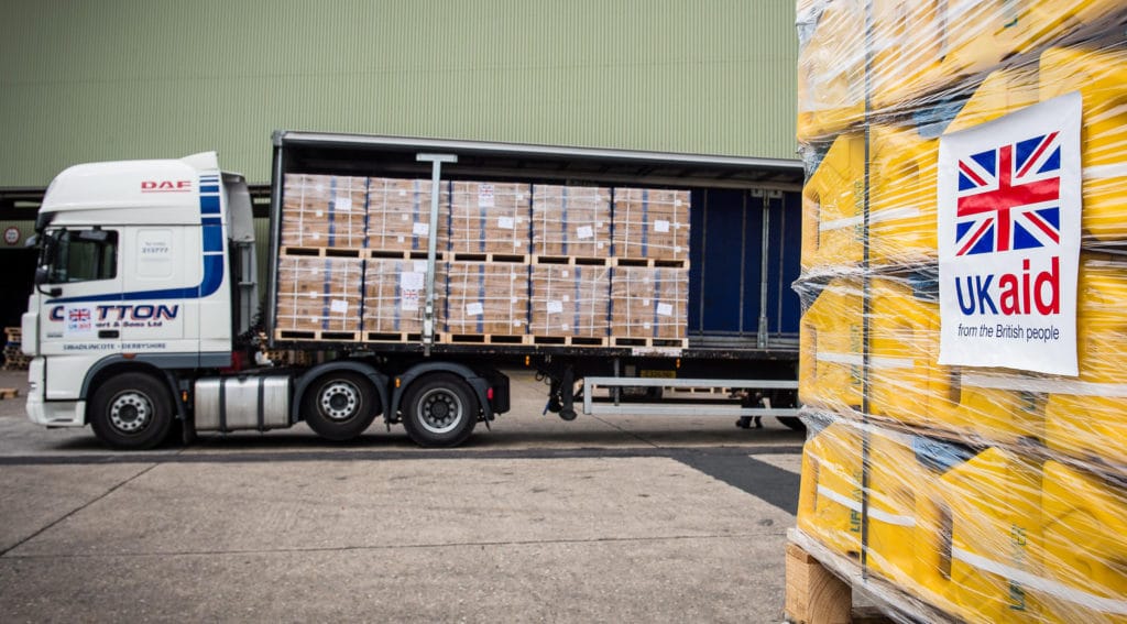 Lorry being unloaded with UK Aid